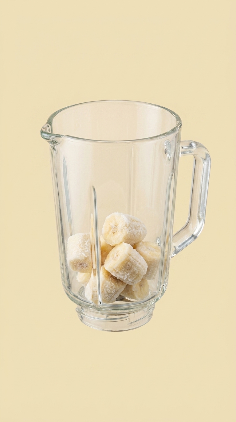 Frozen banana chunks in a clear-glass blender pitcher